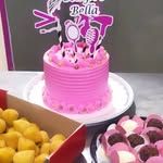 Kit de festa com bolo rosa, docinhos e salgadinhos